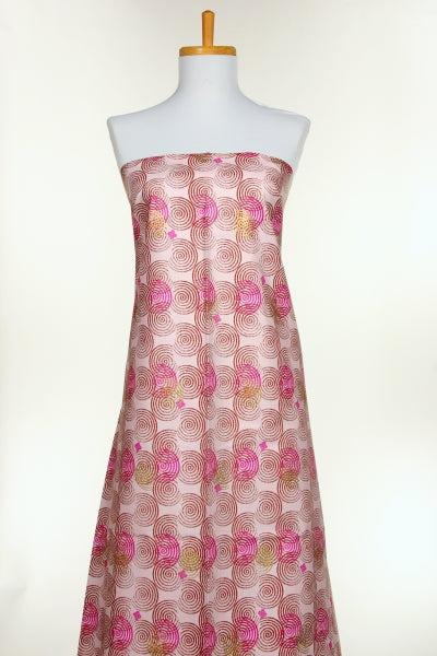 Mannequin wearing a strapless dress with pink floral pattern on a white background
